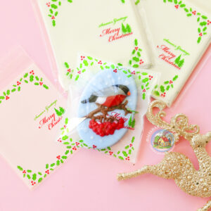 Целофановий пакетик “Merry Christmas, seasons greetings” з клейкою стрічкою, 10*10 см + 3 см